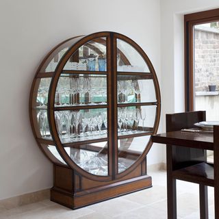 glass cupboard with oval cabinet design and glass collection
