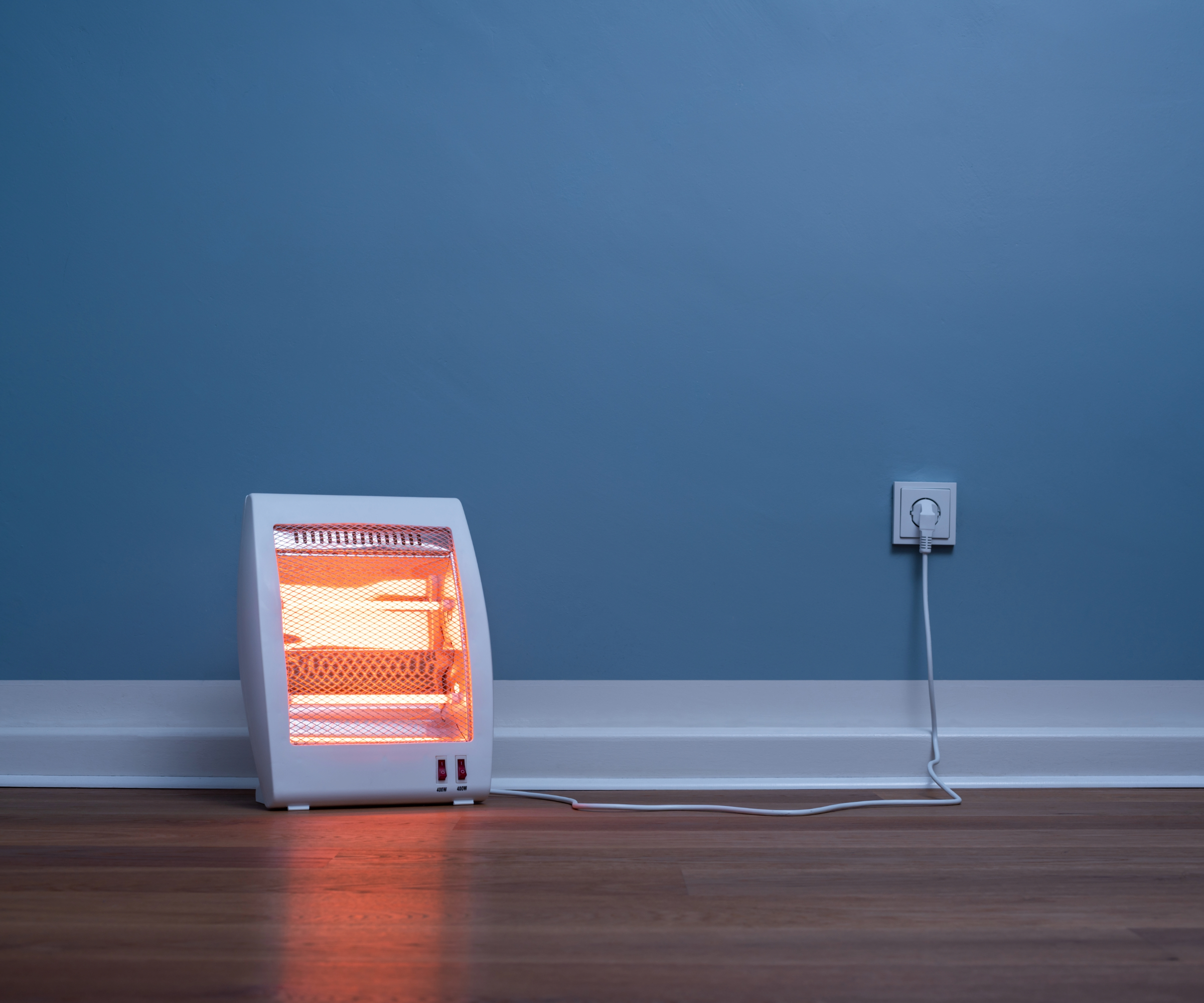 Infrared heater in front of a blue wall