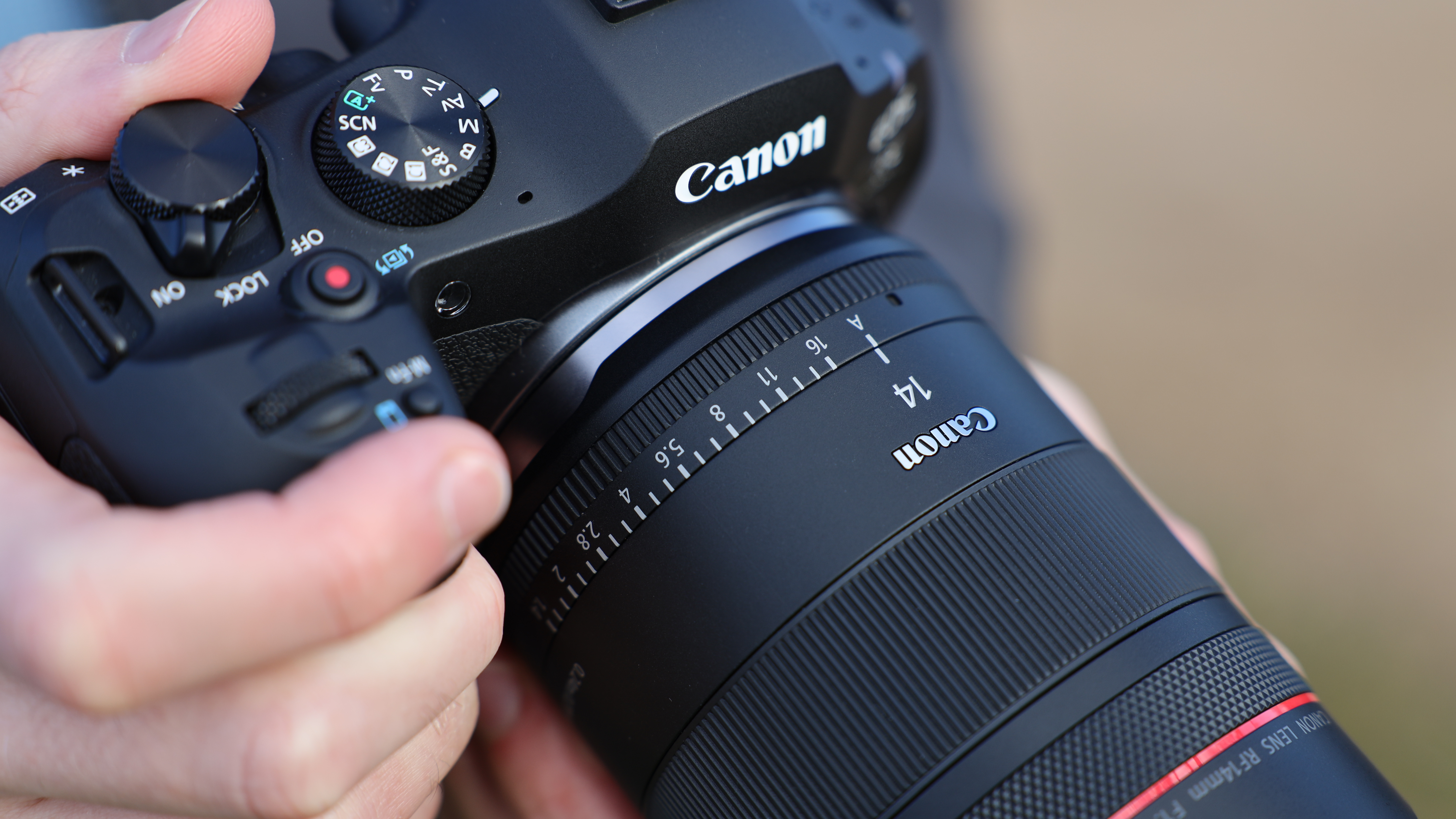 Canon EOS R6 Mark III camera with Canon RF 14mm f/1.4L VCM lens attached held in a pair of hands