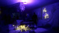 Phasmophobia - A dark figure stands in a room with neon purple lighting and Alan Wake iconography