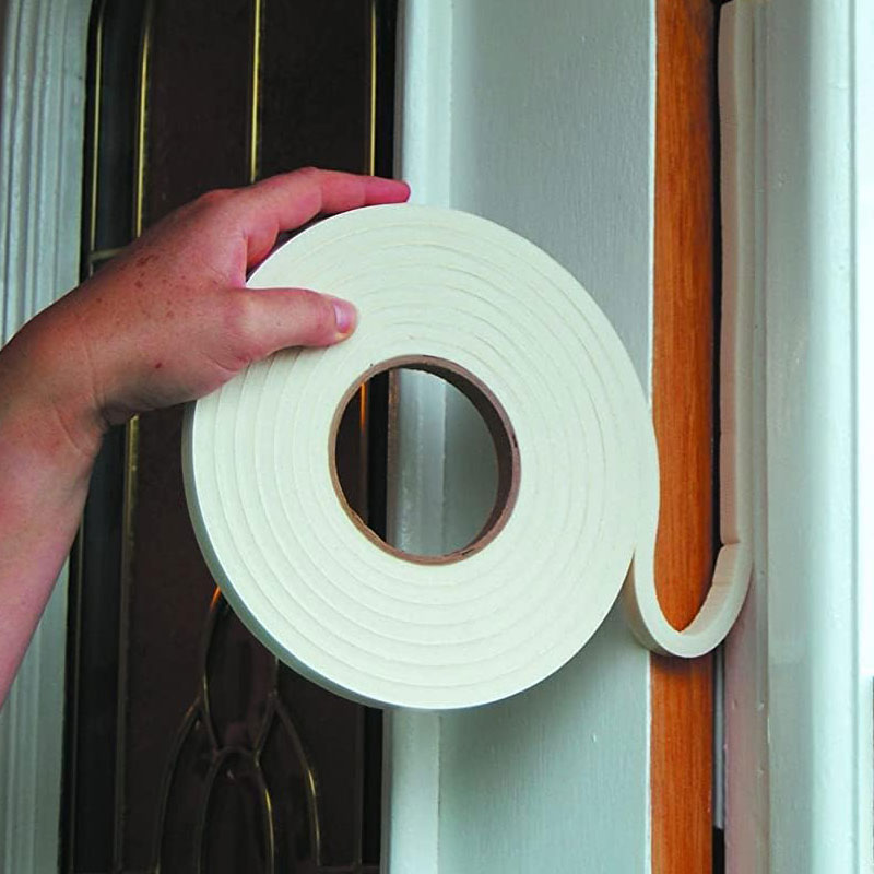 Hand holding self adhesive foam tape and applying to door frame