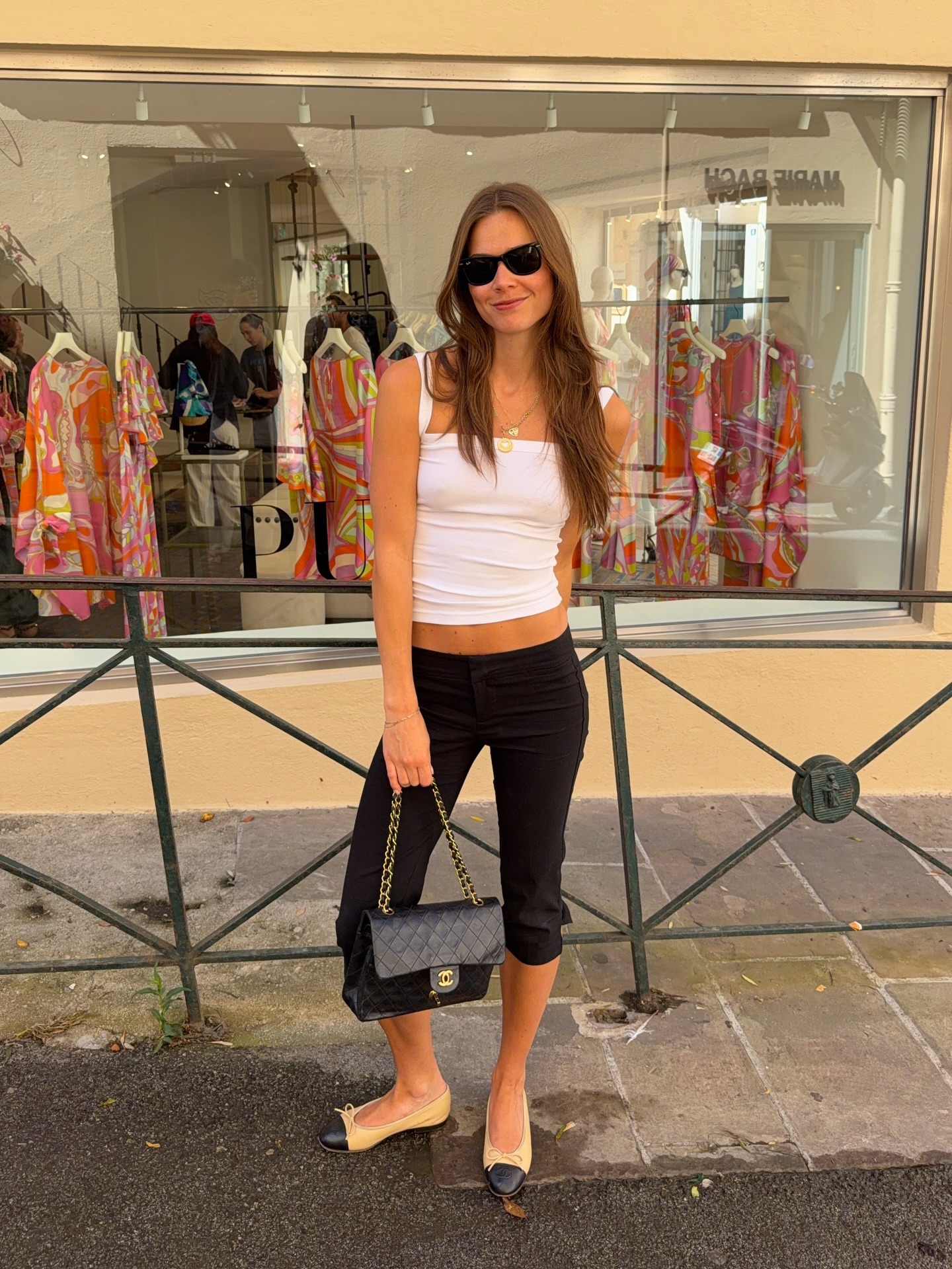 Woman in a tank top and capri pants.