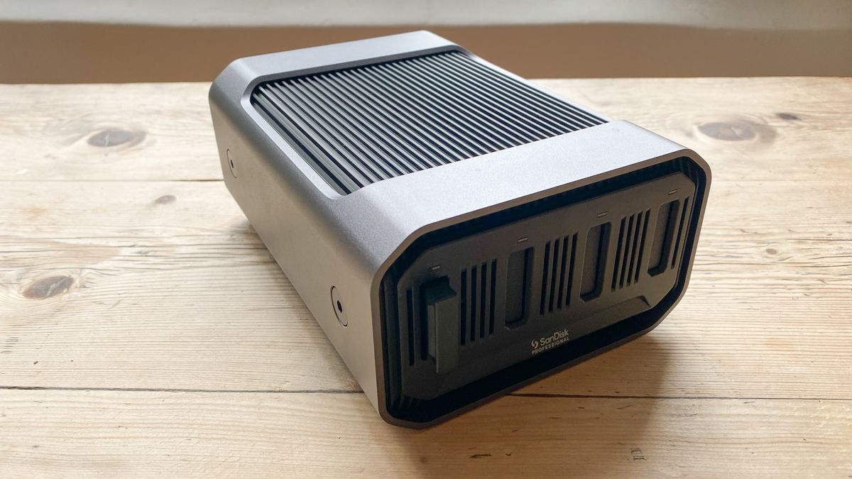 A SanDisk Professional Pro-Blade Station sitting on a wooden desk