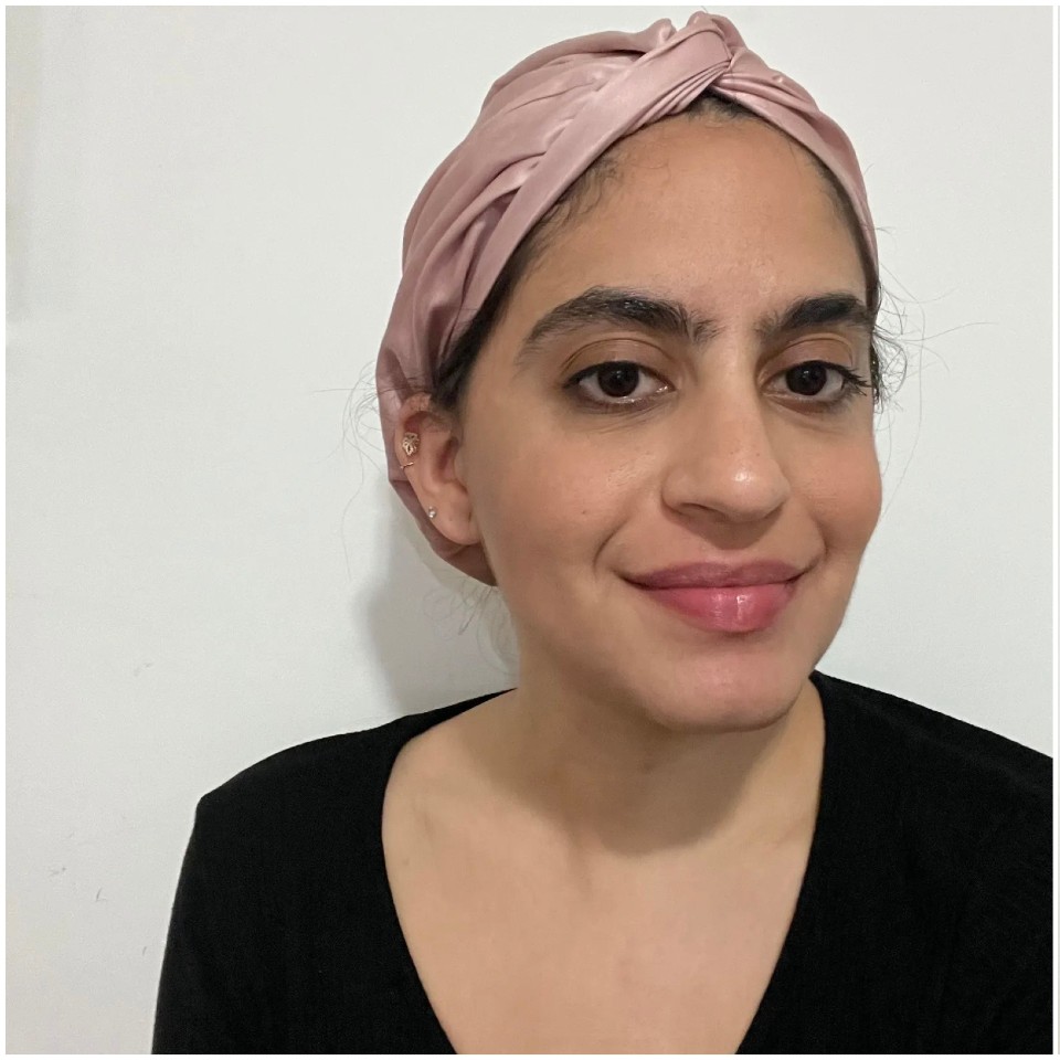 An image of a person wearing a pink silk hair wrap
