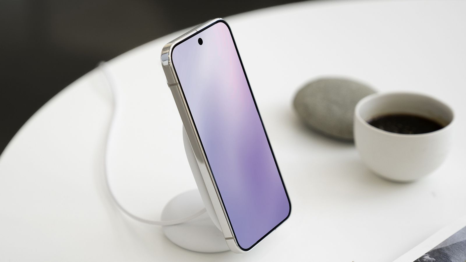 A Pixel phone sitting on a table on a Pixelsnap magnetic stand