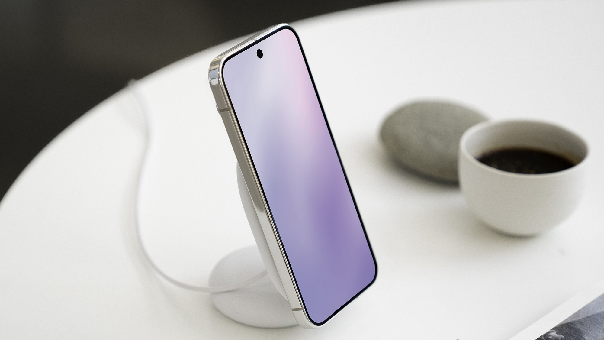 A Pixel phone sitting on a table on a Pixelsnap magnetic stand