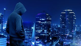 Hacker overlooking a city