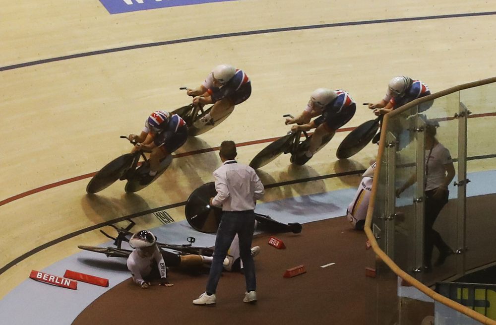 Great Britain passes by the crashed German riders during round 1 of the team pursuit
