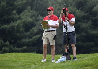 Shotlink volunteers measure yardages during the first round of the World Golf Championships-Bridgestone Invitational at Firestone Country Club on August 3, 2017