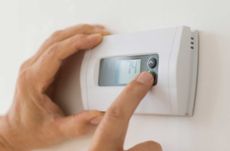 Person operating a thermostat