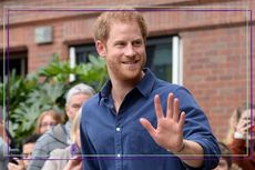 a close up of Prince Harry waving