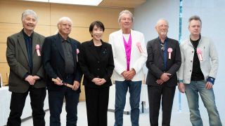 Japan's Prime Minister Sanae Takaichi poses with members of Deep Purple during their meeting the Prime Minister's Office in Tokyo on April 10, 2026 