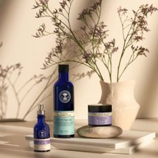 Beauty products sold at Neals Yard Rermedies next to flowers in a vase