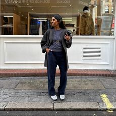 Woman wears Leset elastic waistband pants, Asics sneakers and St. Agni Studio top.