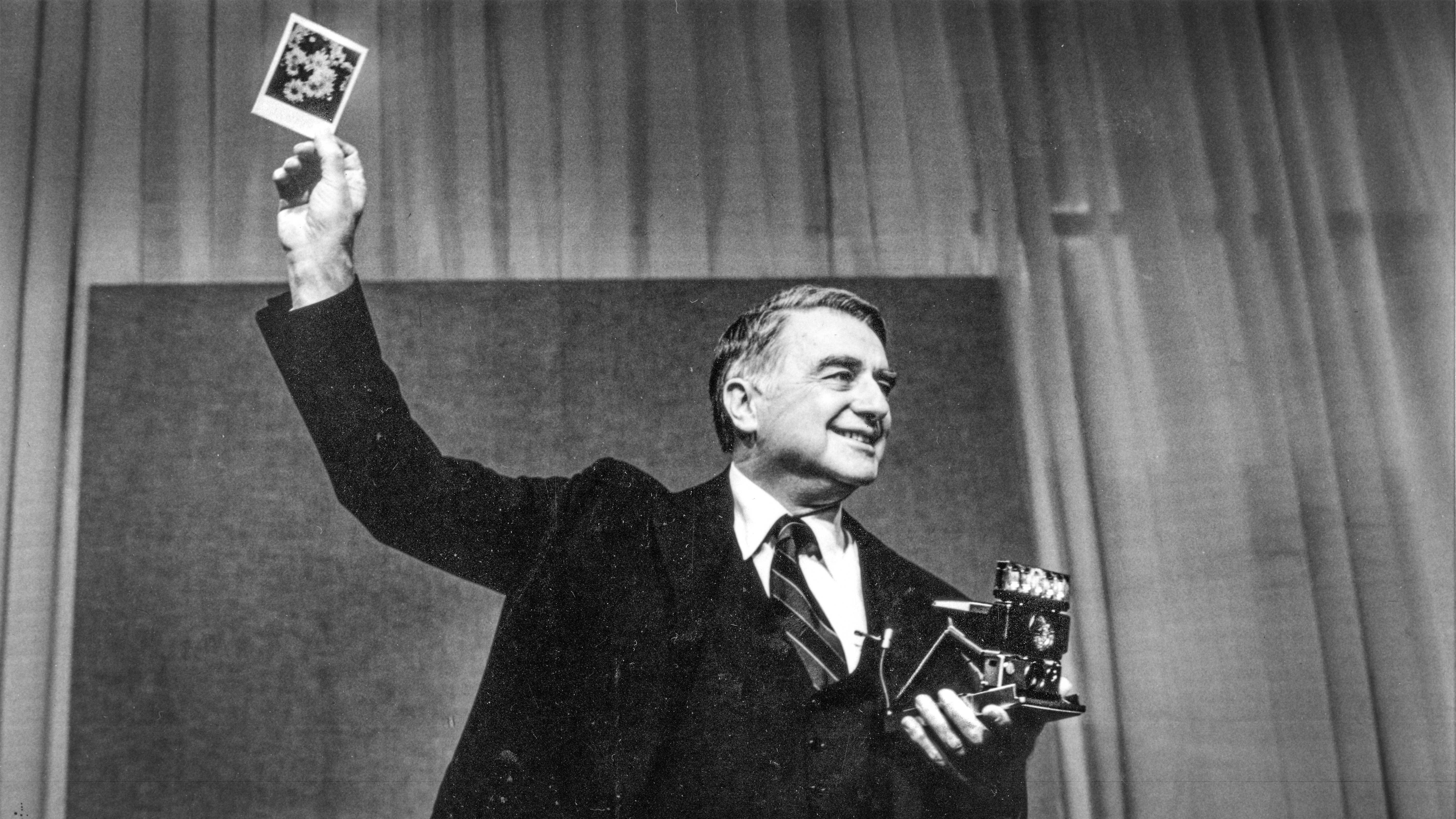 NEEDHAM, MA - APRIL 24: Dr. Edwin H. Land, Chairman of the Board and Director of Research of Polaroid Corporation, shows a print made with the company's new SX 70 color film during a press conference in Needham, MA on Apr. 24, 1979. (Photo by Paul Connell/The Boston Globe via Getty Images)