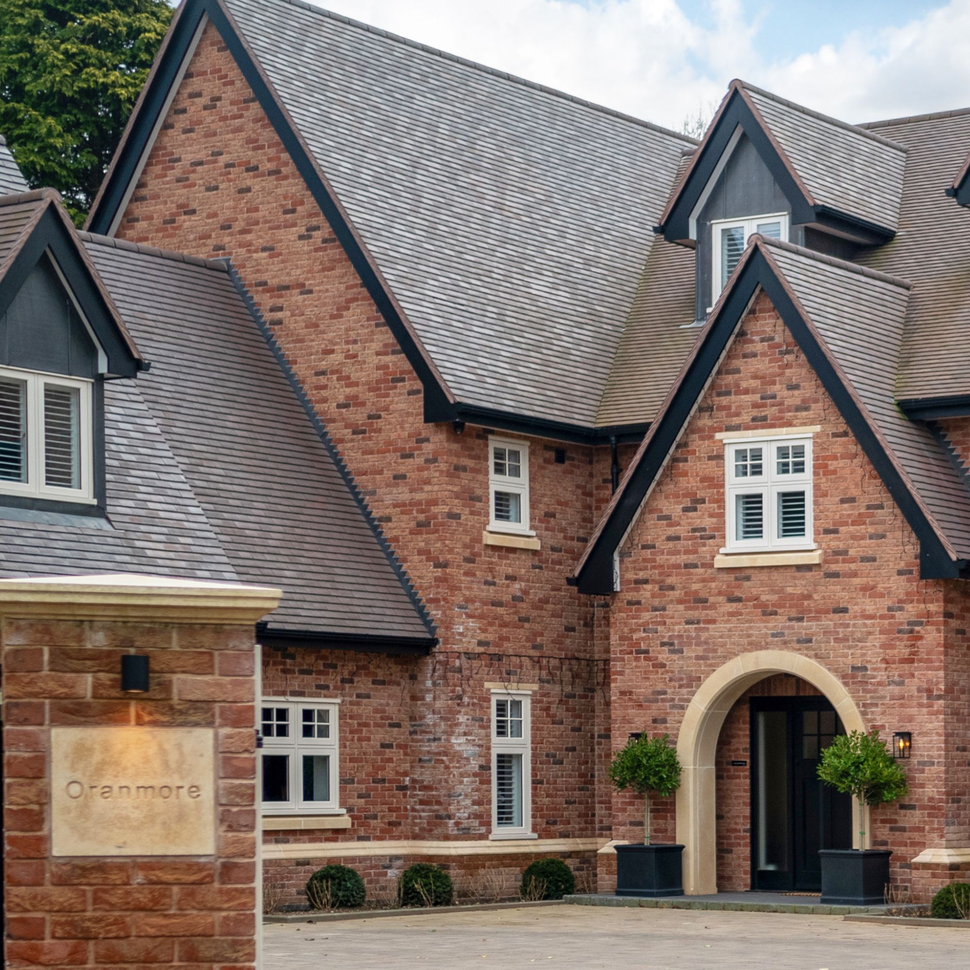 Clay roof tiles on steeply pitched roof with dormers