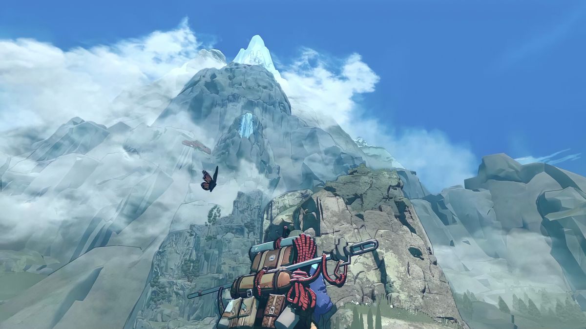 The climber looks up at a mountain while loaded with gear, a bird flying overhead in the clear blue sky, in Cairn