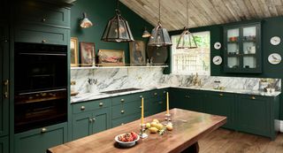 Green kitchen with marble backsplash