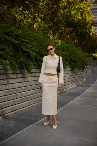 Woman wearing white pointed-toe mules in New York CIty