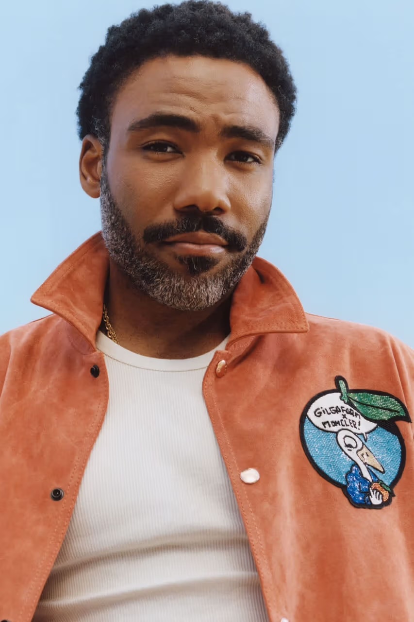 Donald Glover wearing his new range with Moncler including the burnt orange jacket