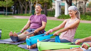 a photo of a senior woman doing exercise holding a resistance band