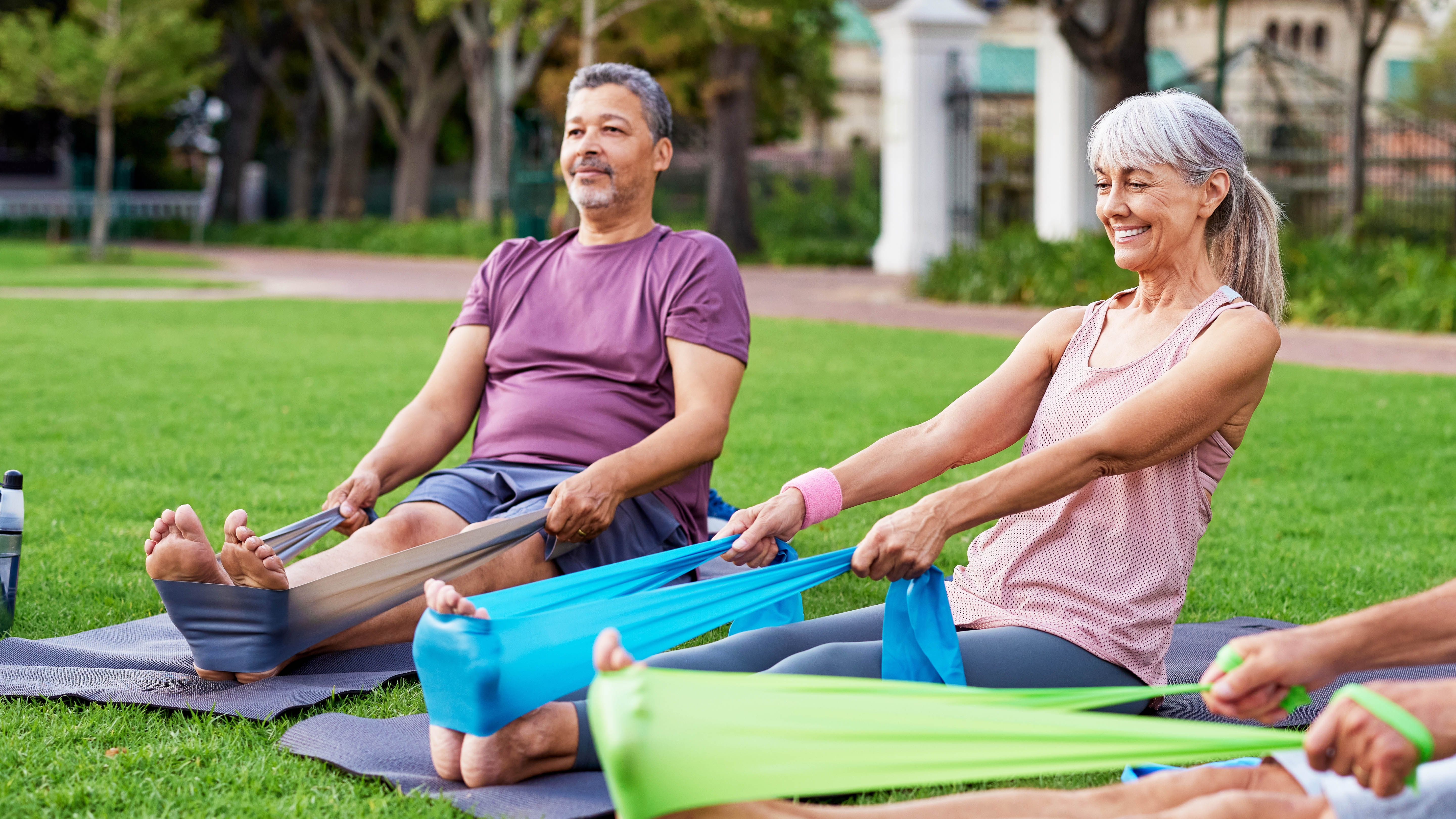 a photo of a senior woman doing exercise holding a resistance band