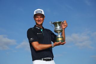 Adrian Meronk of Poland poses with the trophy following victory on Day Four of the DS Automobiles Italian Open at Marco Simone Golf Club on May 07, 2023 in Italy.
