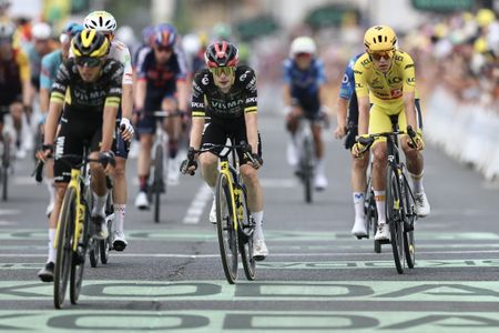 Uno-X Mobility team's Norwegian rider Torstein Traeen wearing the overall leader's yellow jersey (R) and Team Visma | Lease a Bike's Danish rider Jonas Vingegaard (C) cross the finish line of the 5th stage of the 113th edition of the Tour de France cycling race, 158 km between Lannemezan and Pau in southwestern France, on July 8, 2026. (Photo by Anne-Christine POUJOULAT / AFP)
