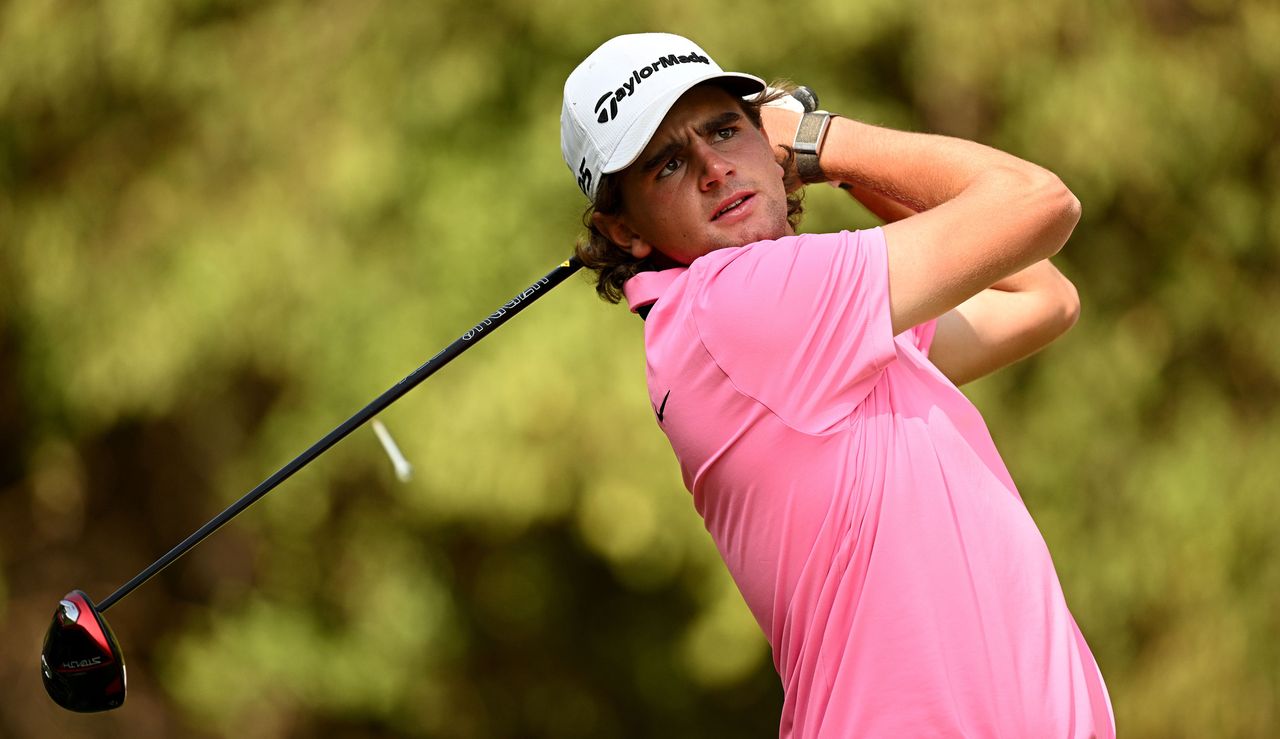 Casey Jarvis hits a tee shot in a pink shirt