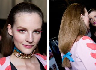 Model hairstyle is big back-combed locks had abruptly sharp ends secured with brightly coloured bows