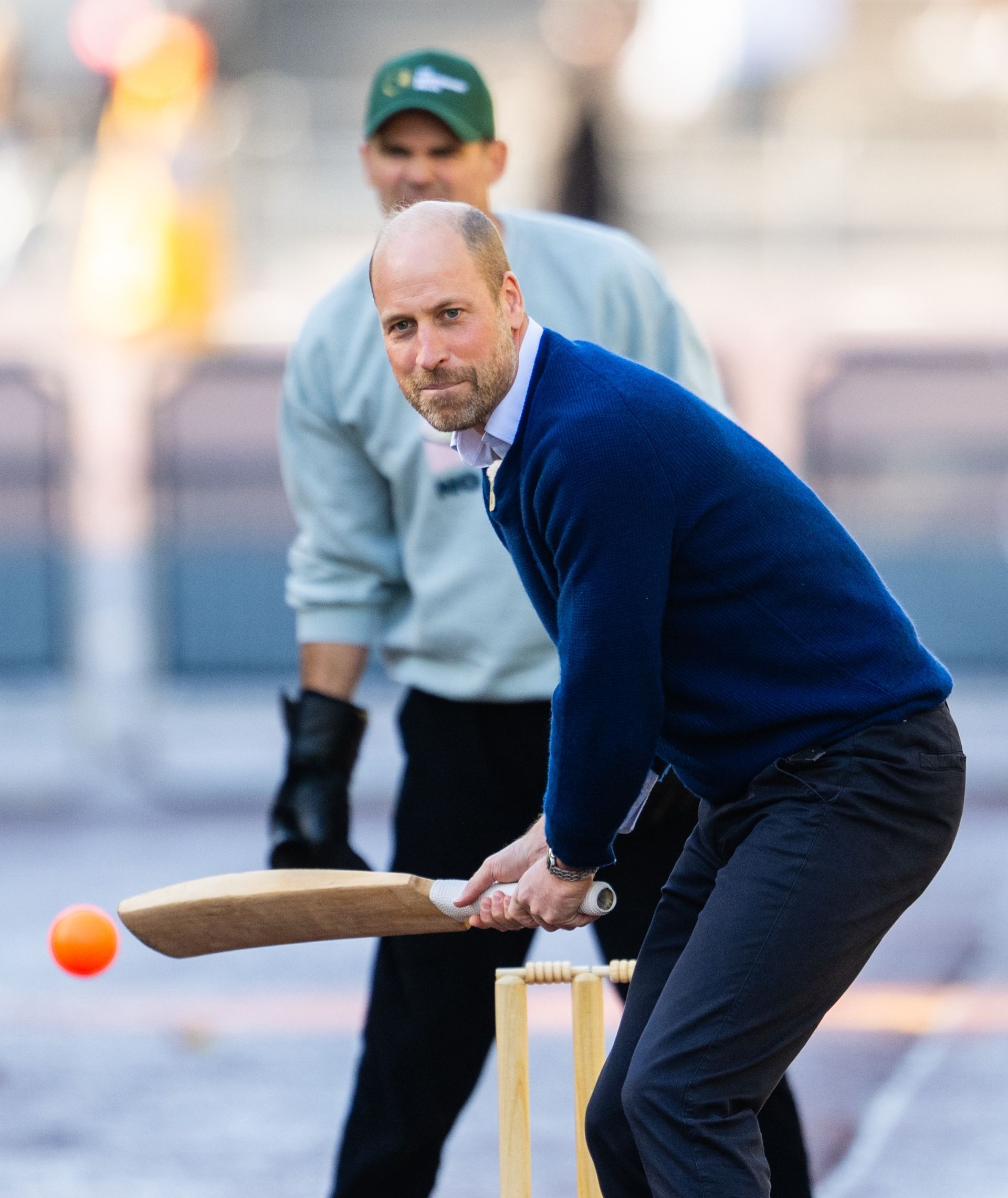 Prince William playing cricket in front of Buckingham Palace