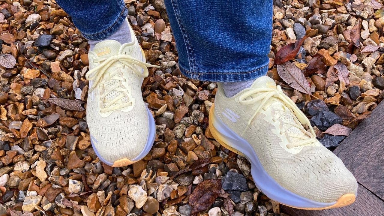 Skechers Women&#039;s Aero Spark Hands Free Slip-ins Sneaker in yellow worn on a gravel path