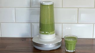 The Millo Smart Portable Blender after fruit and vegetables have been blended into a green smoothie