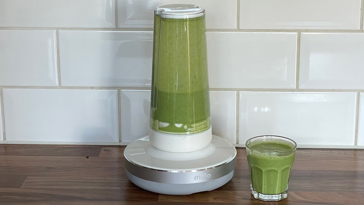 The Millo Smart Portable Blender after fruit and vegetables have been blended into a green smoothie