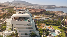 A view across Tenerife's coastline, with the striking white Royal Hideaway hotel in the foreground overlooking the sea