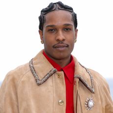 A$AP Rocky attended the Chanel Cruise 2026 fashion show with a pink Chanel Flap bag and a girl dad bag charm