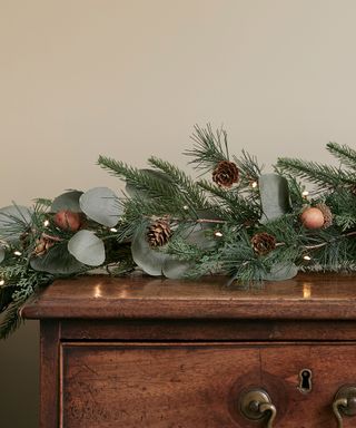 christmas greenery laying on wooden surface