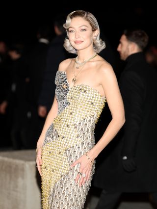 A photo of Hadid color-coordinating the beads of her metallic dress with her silvery platinum hair color.