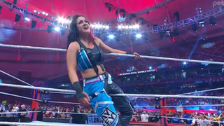 Bayley celebrating between the ropes after winning The Royal Rumble.