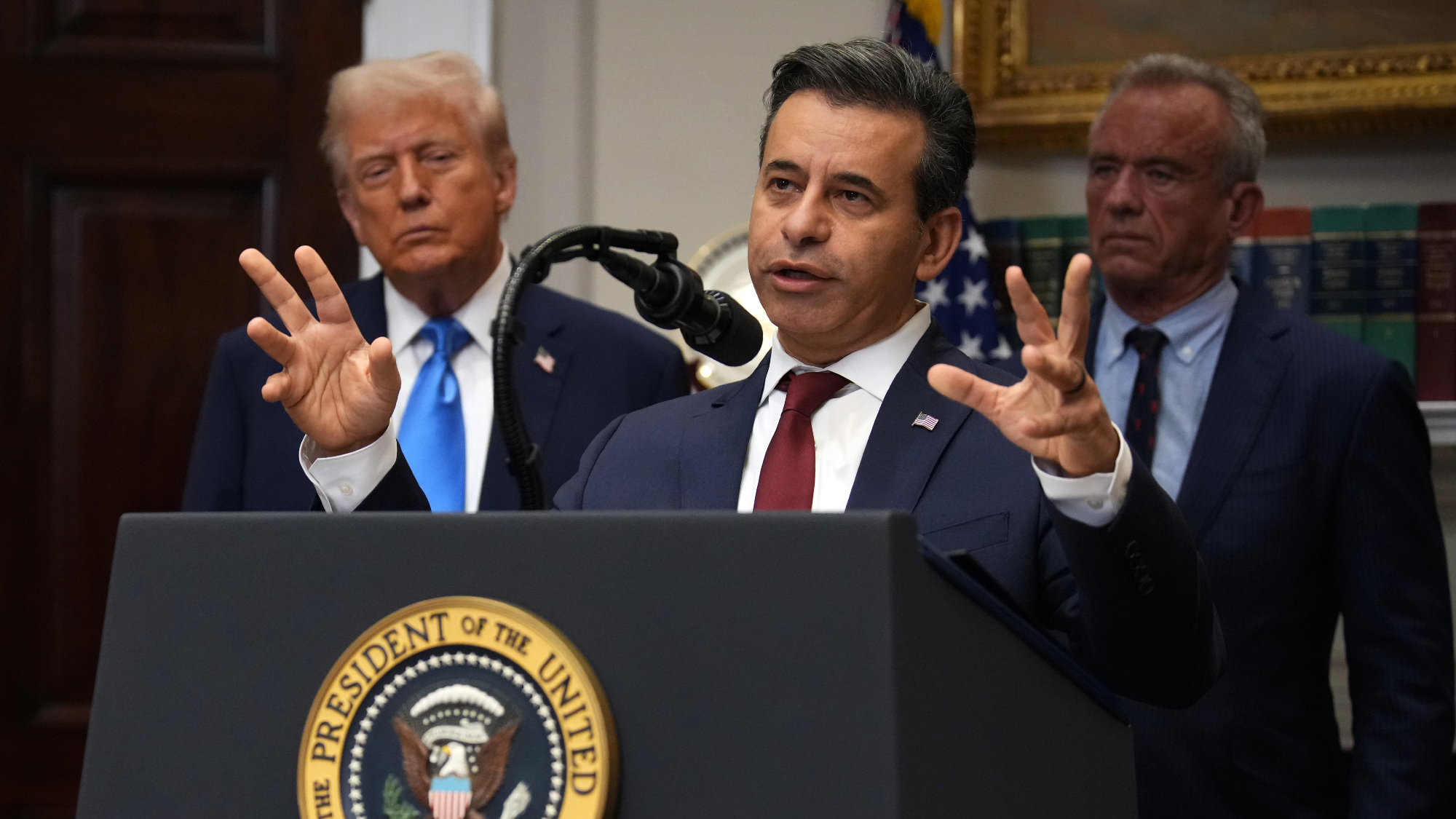 FDA Commissioner Martin Makary speaks with President Trump behind him