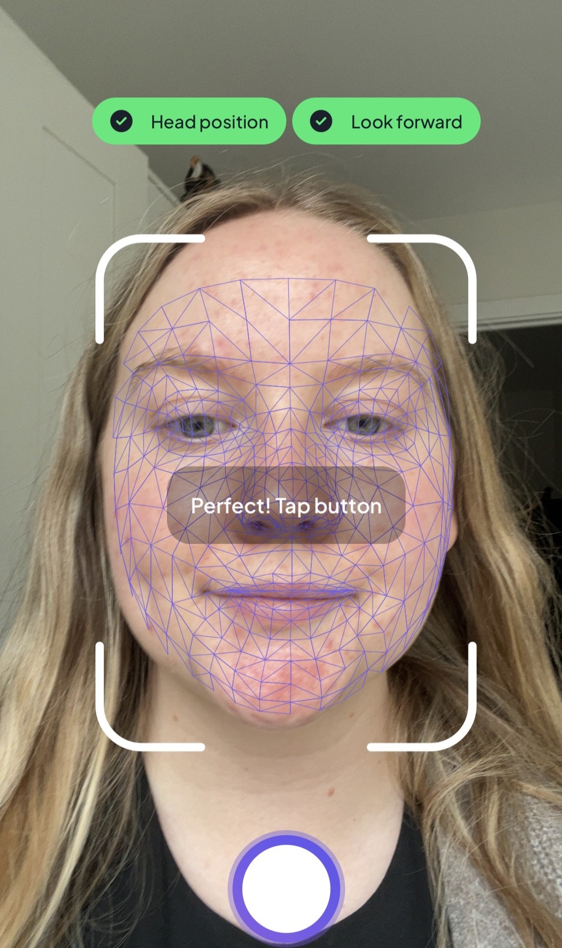 Becky Spicer taking a photo with the Noli AI face scanner
