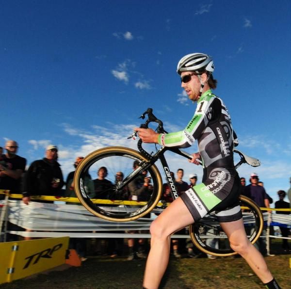 Jamey Driscoll (Cannondale-Cyclocrossworld.com) running the barriers in third place.