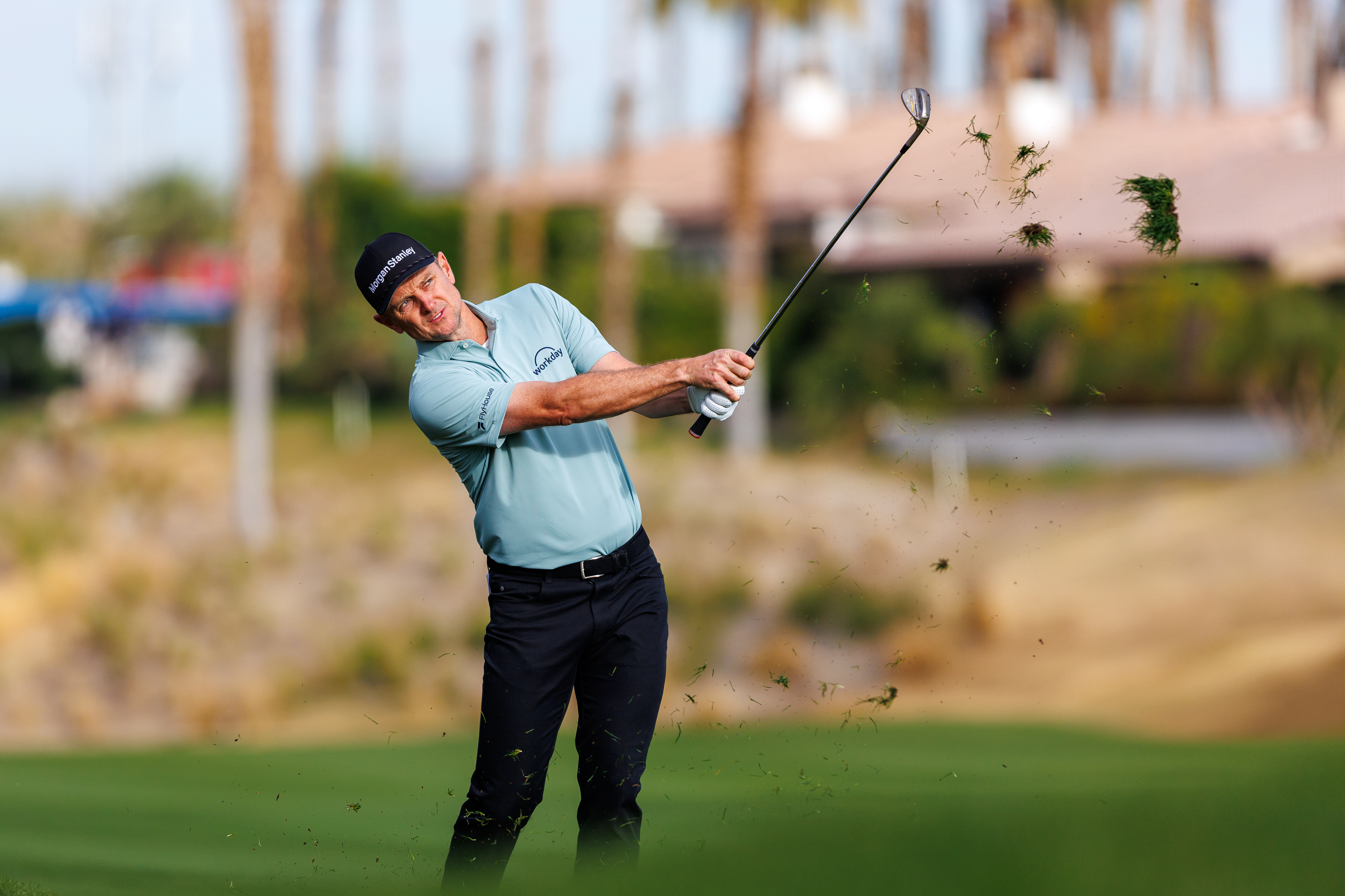 Justin Rose hits a wedge shot from the fairway