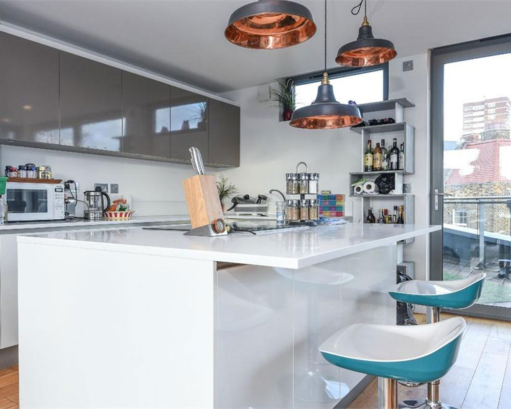 kitchen room with wooden flooring and white kitchen countertops