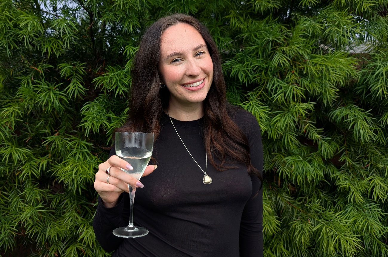 Delaney Seven with glass of white wine