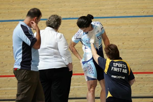 Cassandra Kell (NSW) checks her kit after crashing in the keirin.