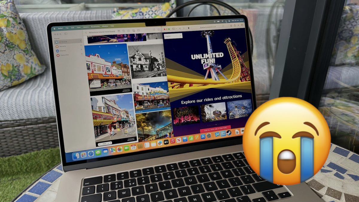 An image of a crying face emoji over a MacBook Air