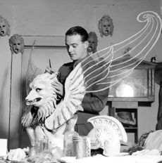 Black and white picture of a man painting a stage prop