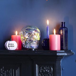 room with dark blue wall and candles