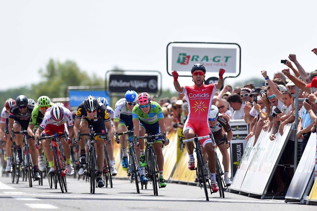 Nacer Bouhanni celebrates as he crosses the line